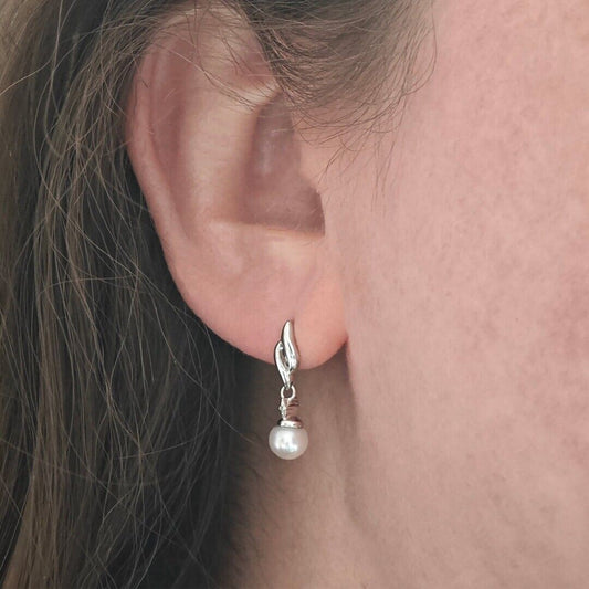 Silver pearl earrings with tiny diamond accent, freshwater pearls dangle style on ear