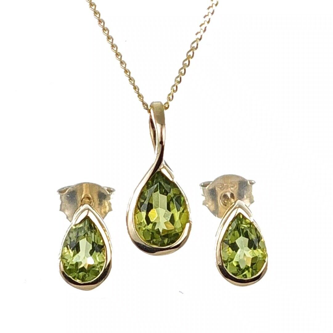 9ct gold peridot necklace and earring set on white background