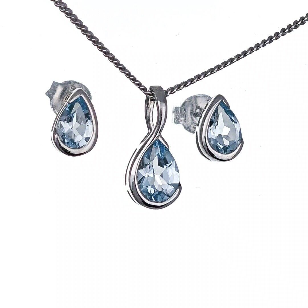 blue topaz set sterling silver pendant stud earrings infinity loop designed in the UK