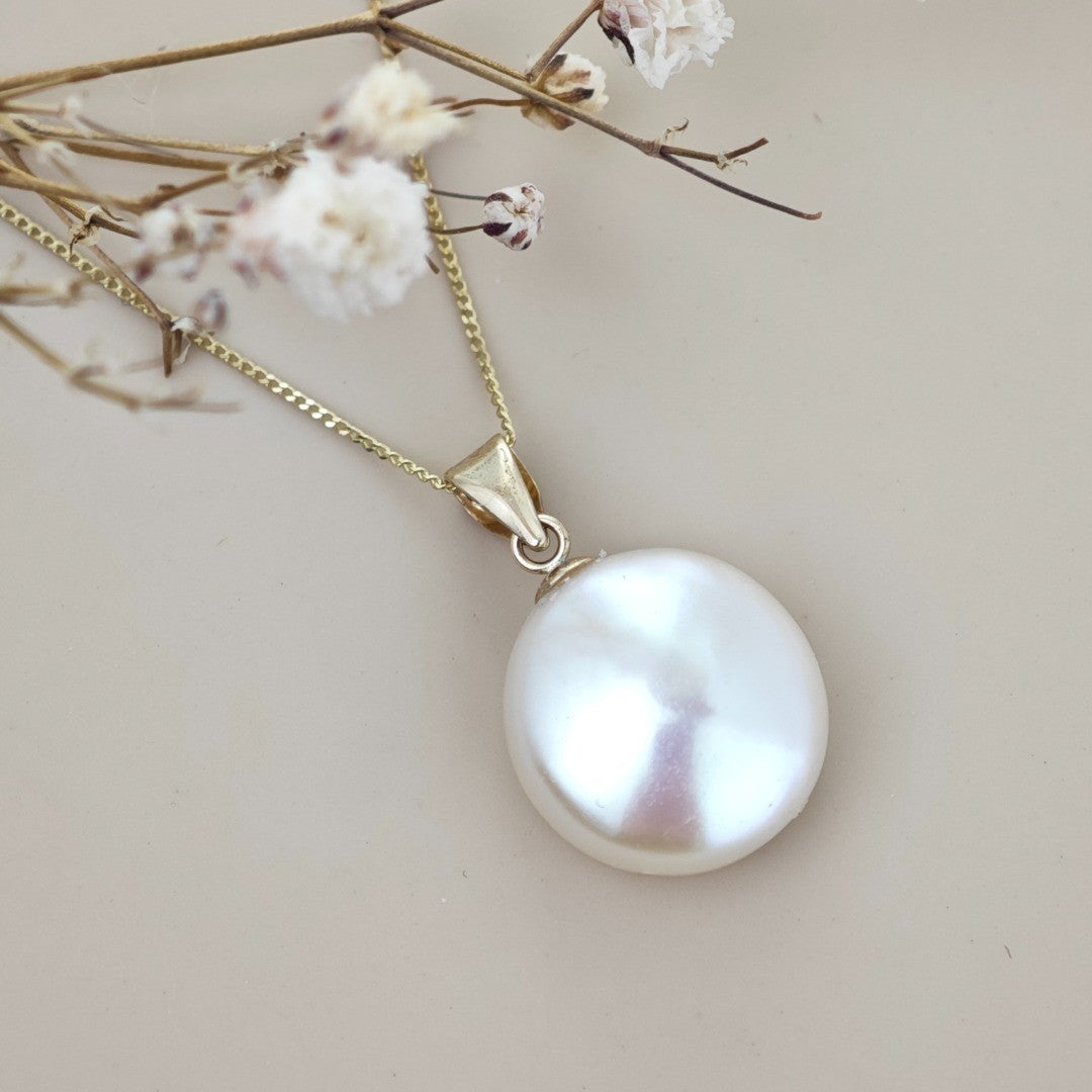 9ct gold disc pearl necklace on natural background side view