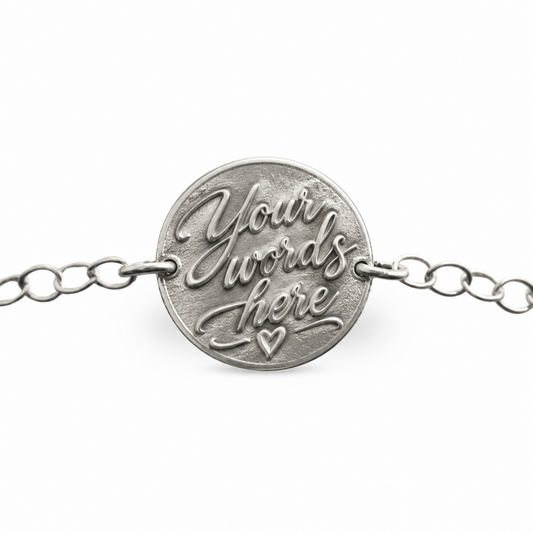 Custom embossed silver bracelet charm, personalised 14mm sterling silver bracelet handcrafted in the UK, angled view