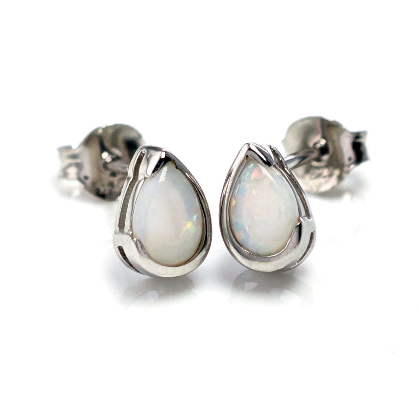 Teardrop-shaped opal earrings on a white background