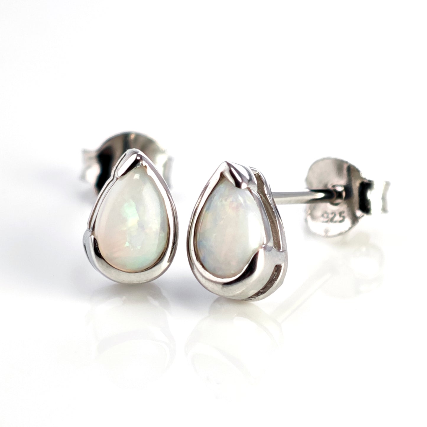 Teardrop-shaped opal earrings on a white background