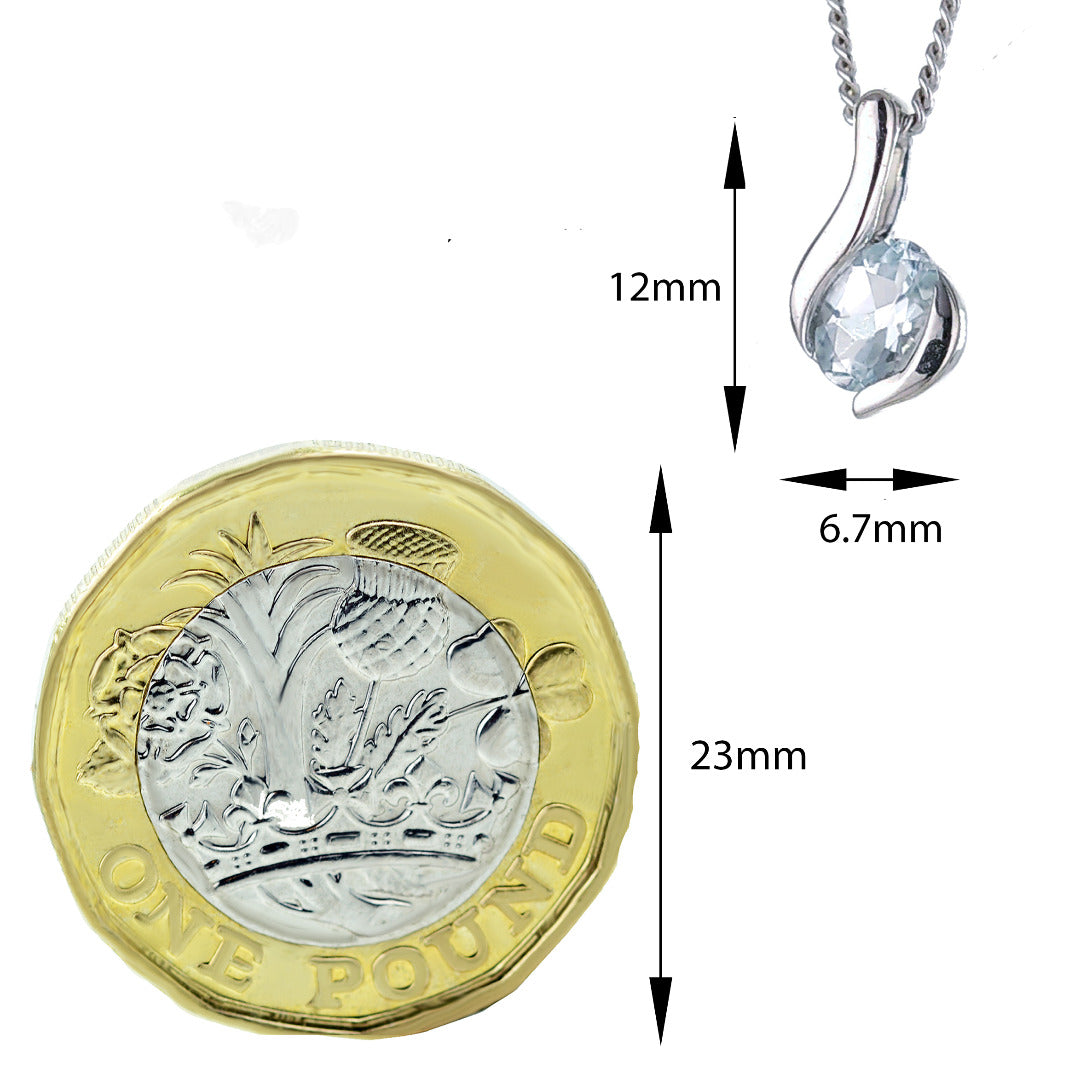 Aquamarine pendant in sterling silver shown agains a one pound coin for scale