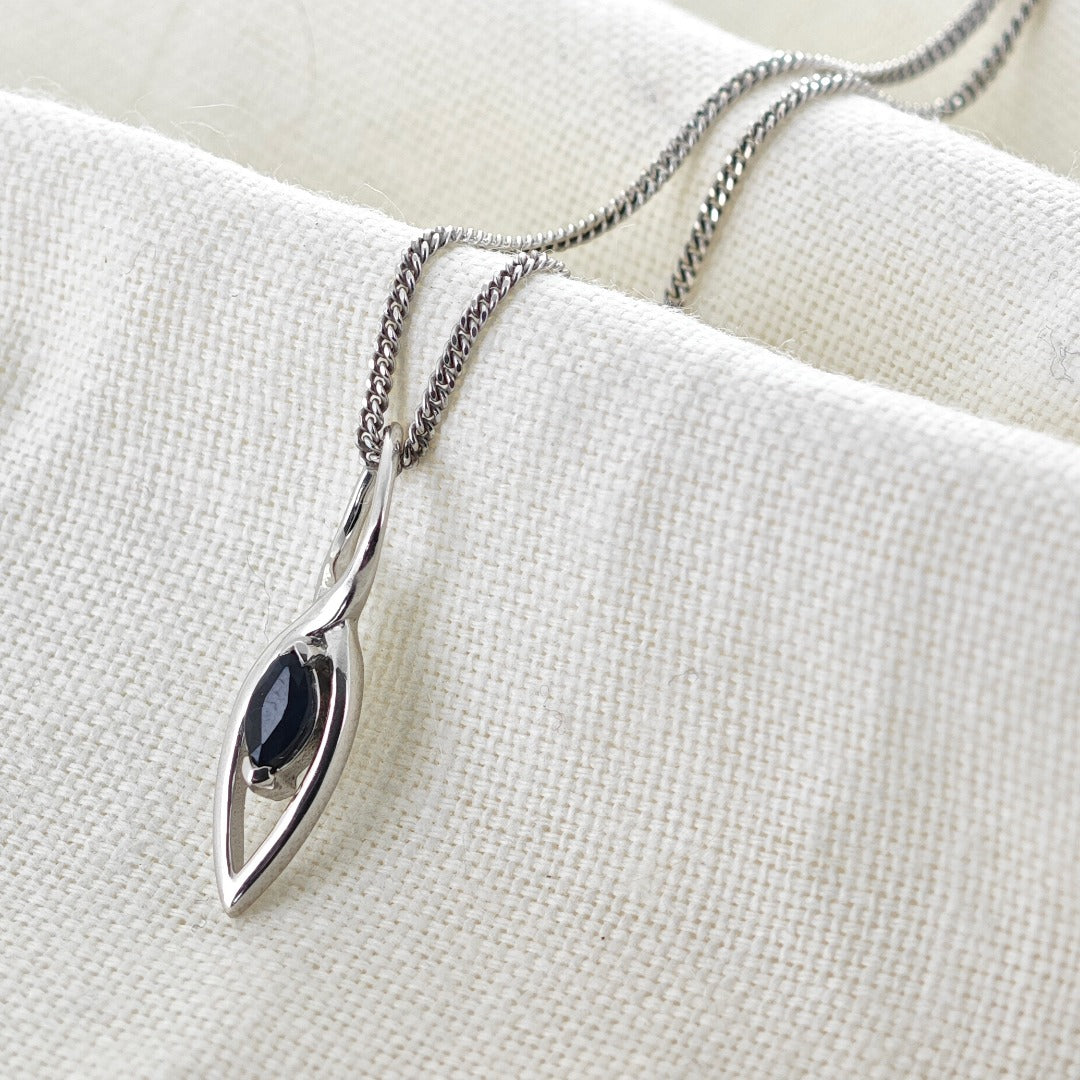 Australian Inky Blue Natural Sapphire Pendant made of Sterling Silver on cotton cloth