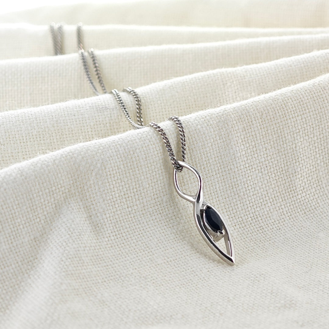 Australian Inky Blue Natural Sapphire Pendant made of Sterling Silver on cotton cloth