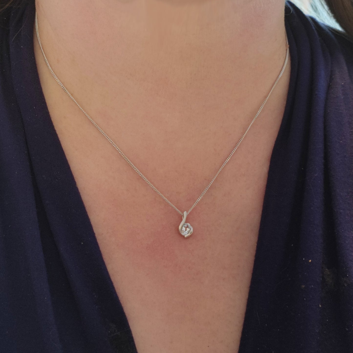 Aquamarine pendant on sterling silver necklace worn on model