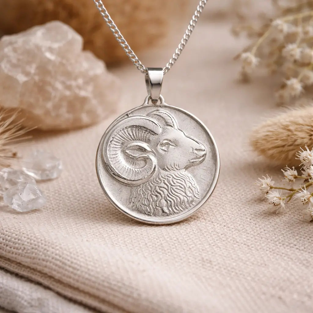 sterling silver ram pendant on natural elements background