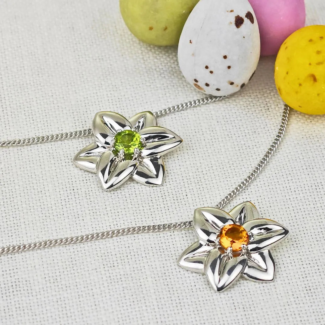 Daffodil pendants with peridot or citrine centre on fabric with mini easter eggs