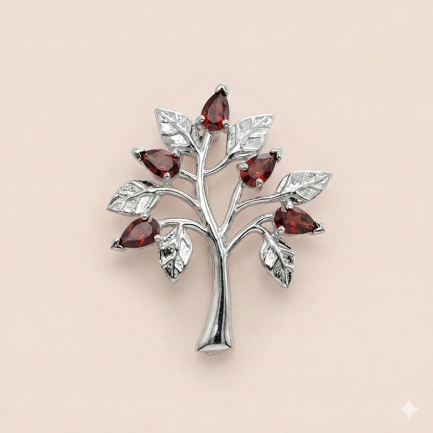 Tree of life brooch in sterling silver set with red garnet