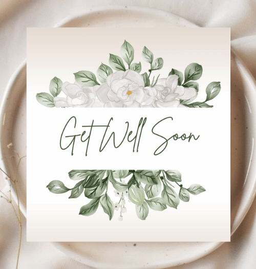 Card with 'Get Well Soon' text and floral design on a white plate.