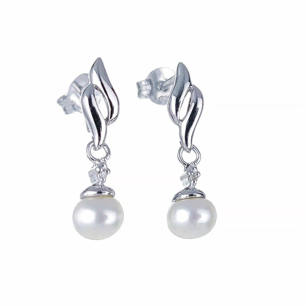 Silver pearl earrings with tiny diamond accent, freshwater pearls dangle style on white background side view