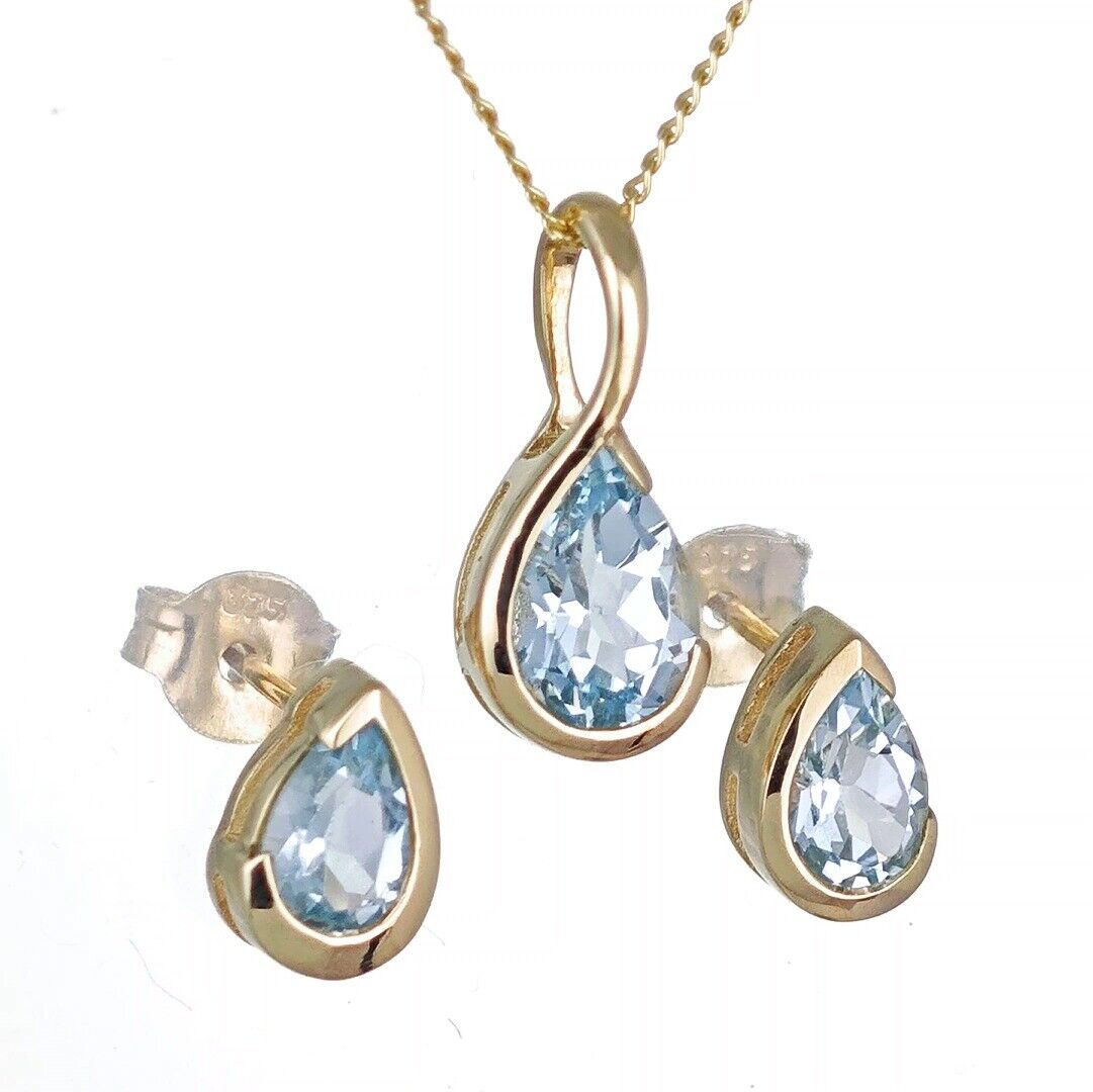 9ct yellow gold blue topaz set pendant stud earrings infinity loop designed in the UK
