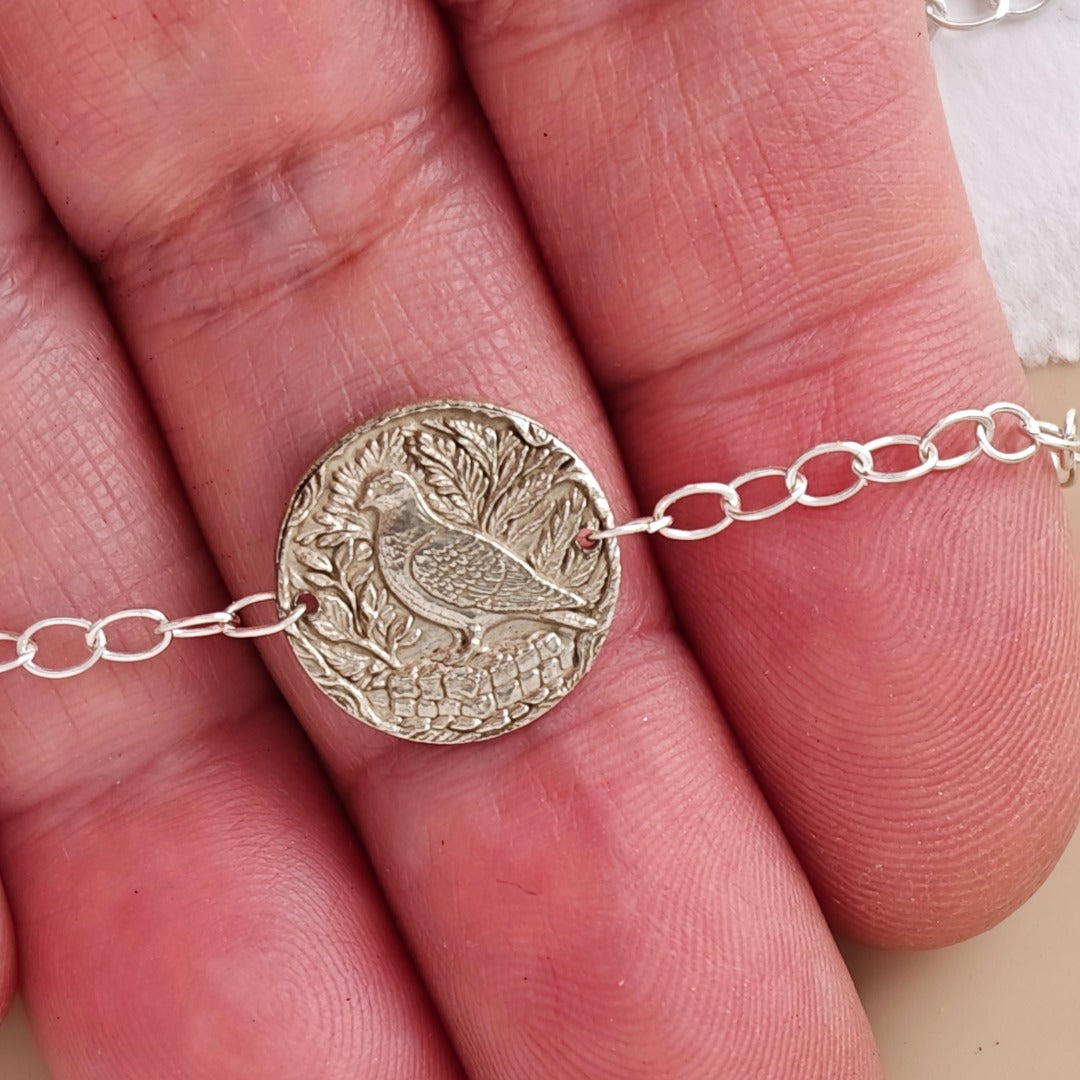 Pigeon coin bracelet - engraving detail