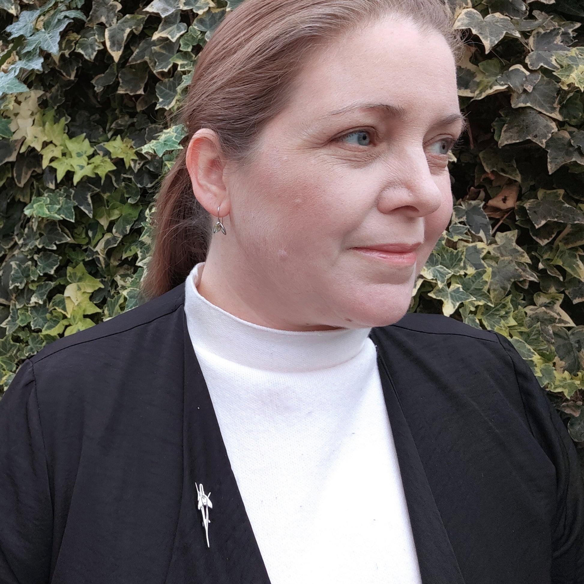 Peridot snowdrop brooch and matching earrings shown on worn