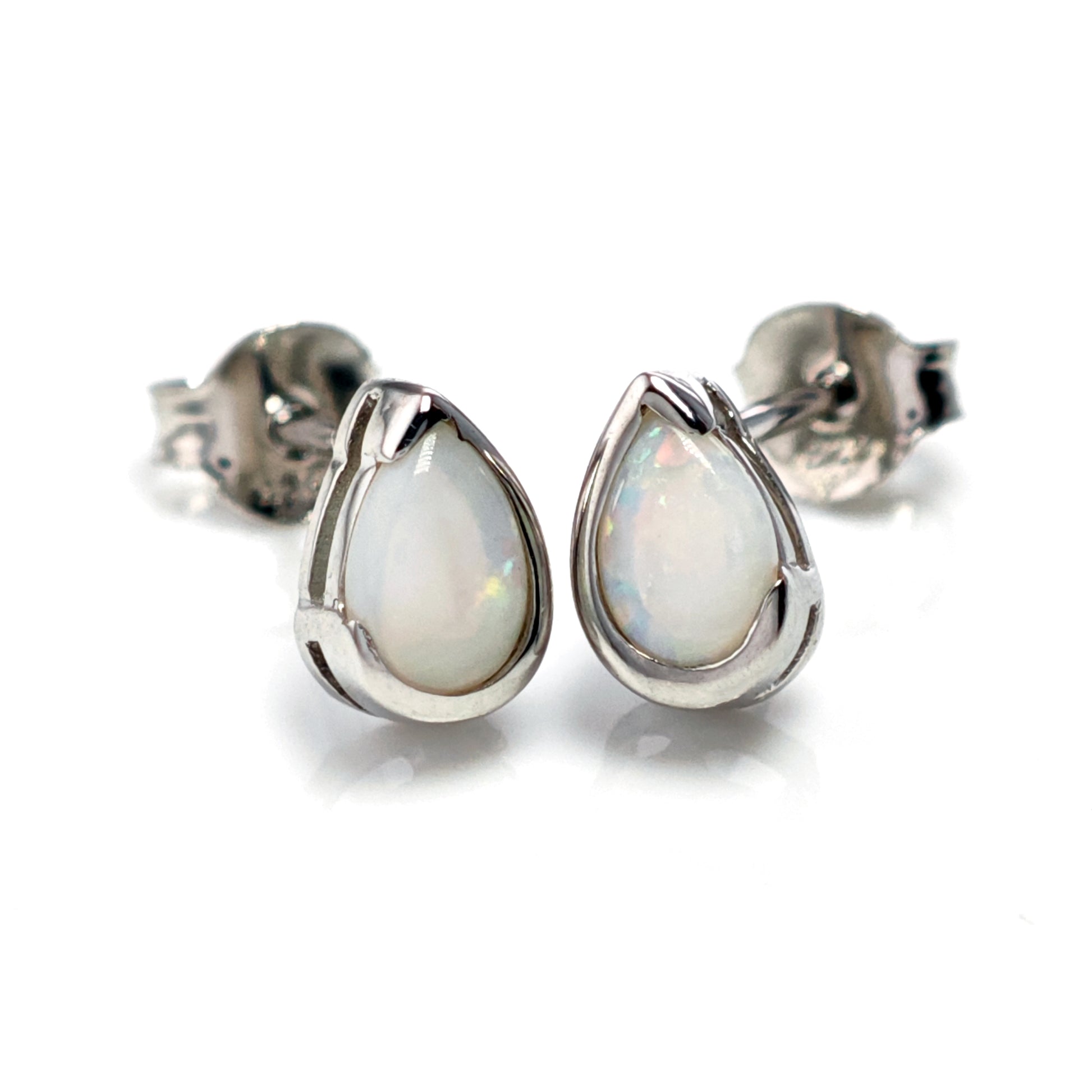 Teardrop-shaped opal earrings on a white background