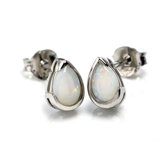 Teardrop-shaped opal earrings on a white background