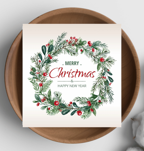 Christmas card with wreath design on a wooden plate