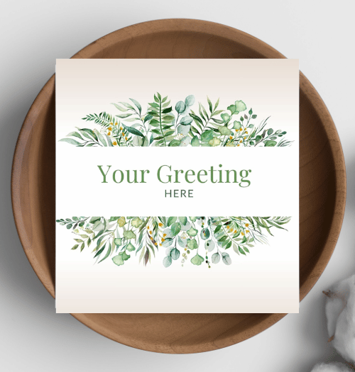 Greeting card with green leaf design on a wooden plate