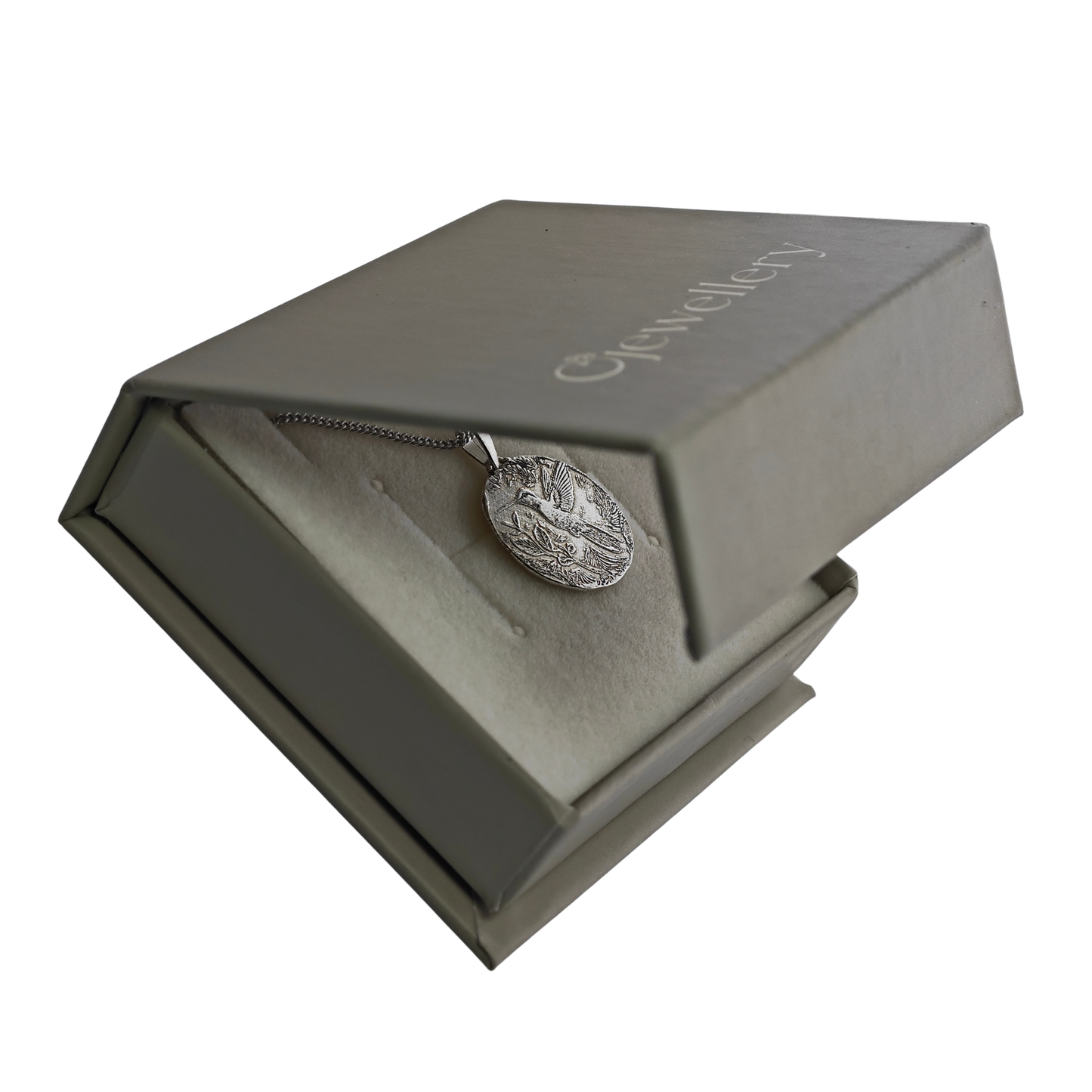 Silver necklace in an open sage jewellery box with 'Ojewellery' branding.