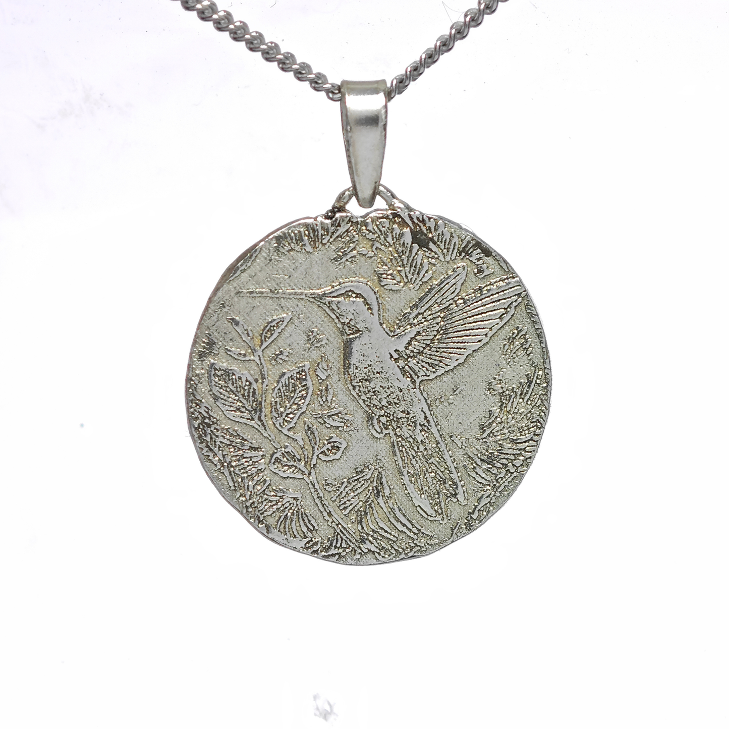 Silver pendant with bird design on a white background