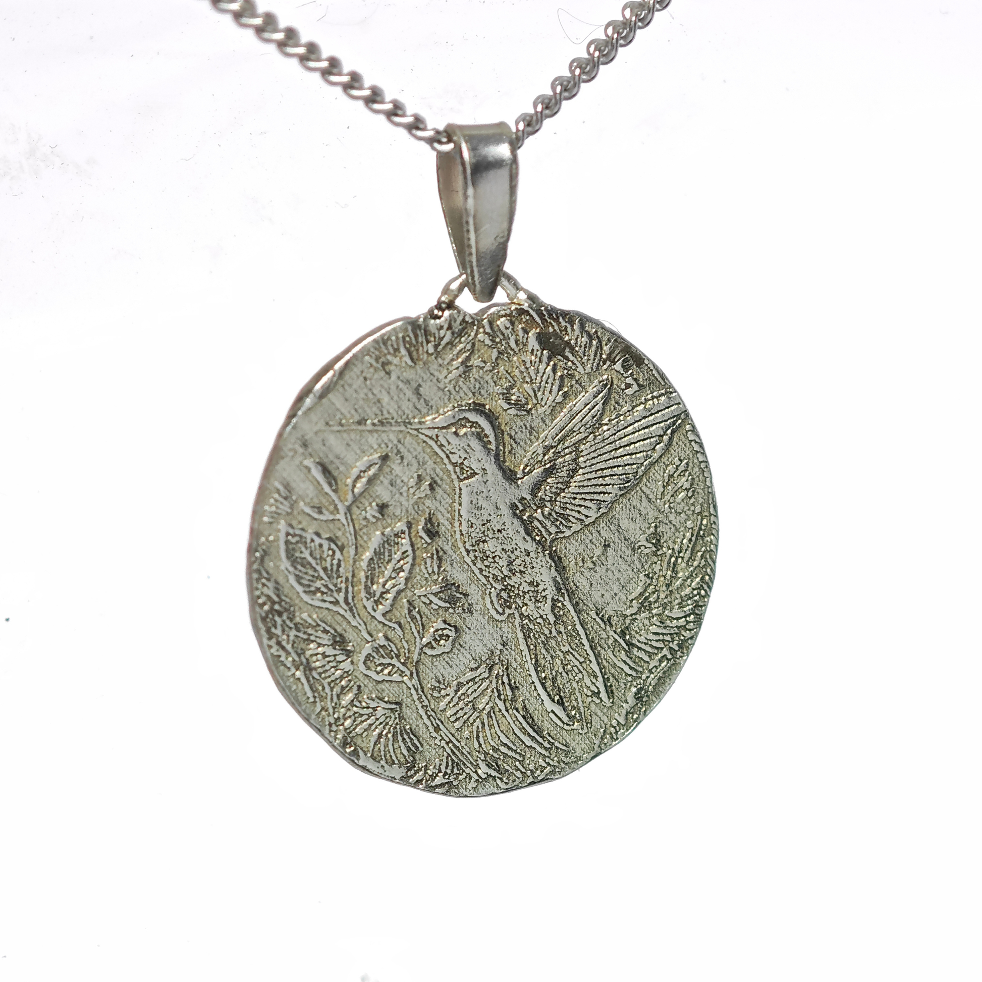 Silver pendant with bird design on a white background