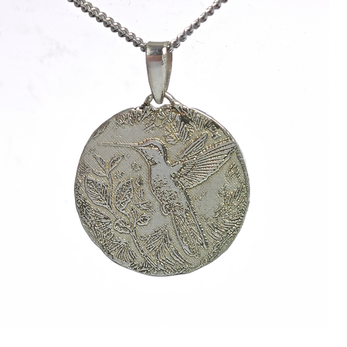 Silver pendant with bird design on a white background