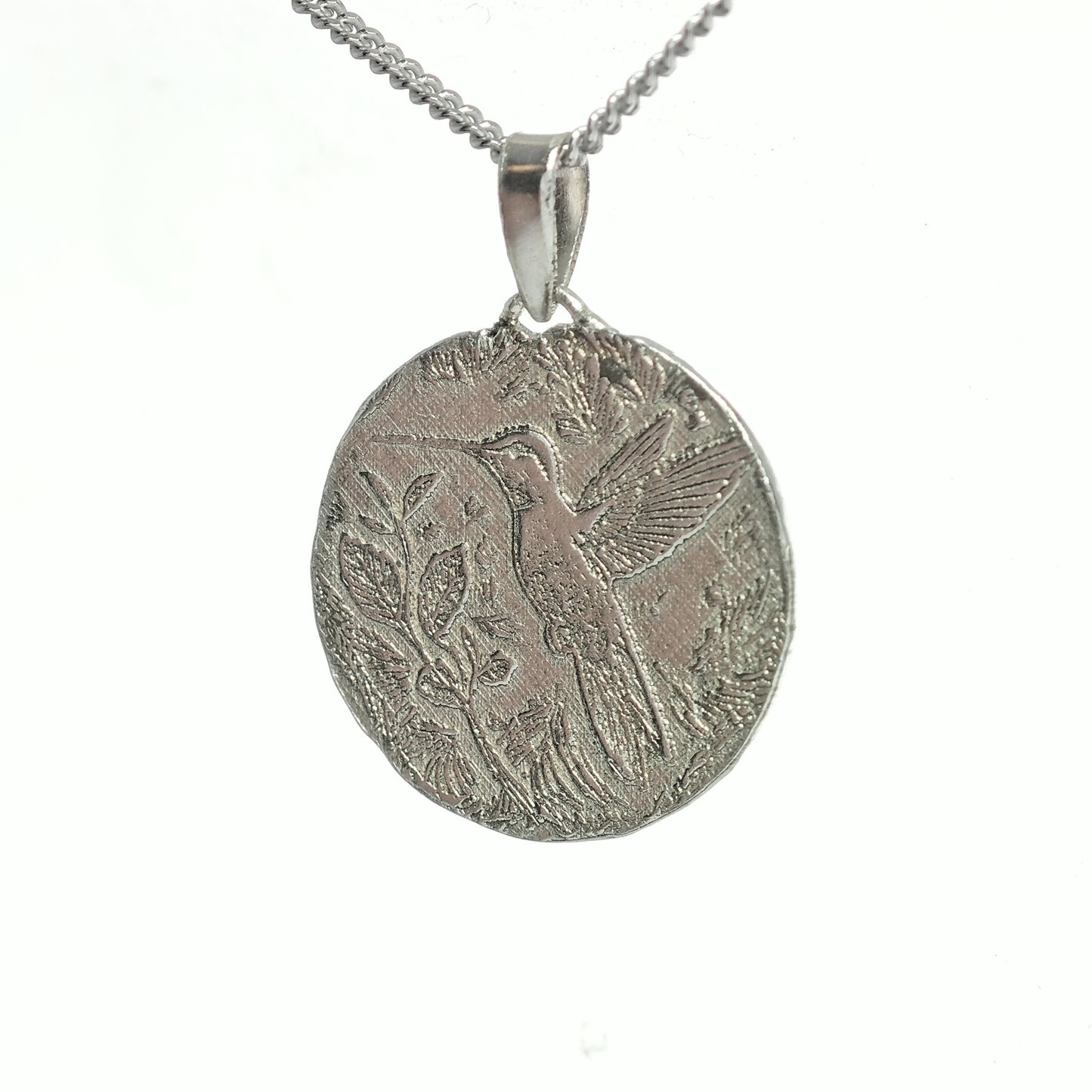 Silver pendant with bird design on a white background