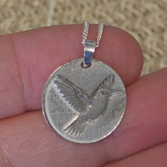 Hummingbird deep engraved sterling silver pendant hown being laser engraved, fitted with bale and final polished