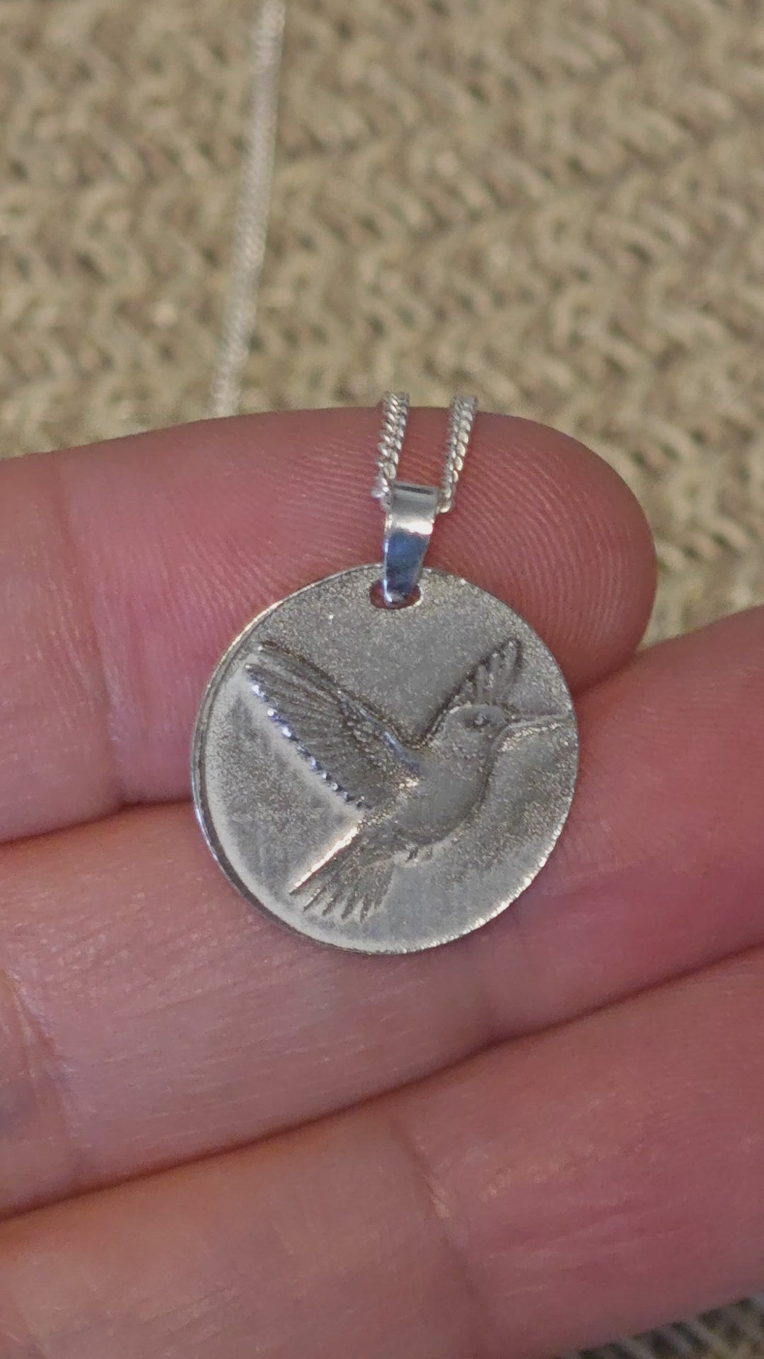 Hummingbird deep engraved sterling silver pendant hown being laser engraved, fitted with bale and final polished