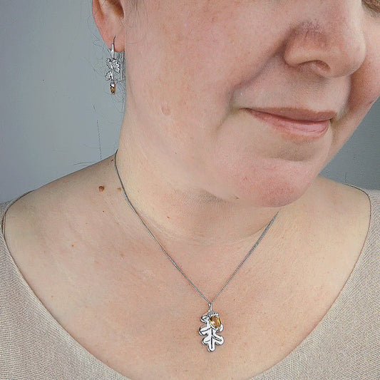 Oak leaf acorn pendant dangle earrings in sterling silver on model