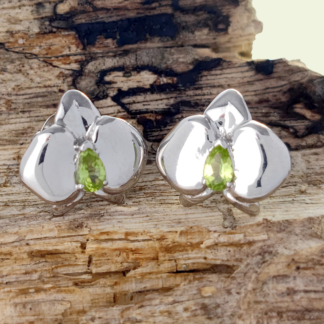 Peridot orchid flower earrings sterling silver on log