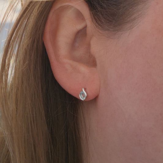 Aquamarine stud earring shown on ear